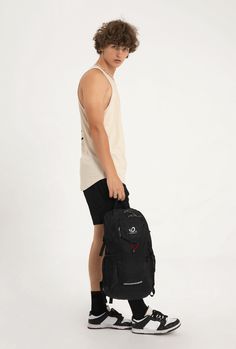 a young man carrying a black backpack