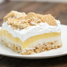 a piece of cake on a white plate with some crackers in the top layer