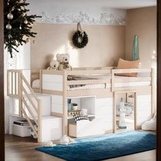 a white bunk bed sitting next to a christmas tree on top of a wooden floor