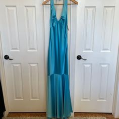 Baby Blue Halter Gown With Low Back Fitted Light Blue Gown, Light Blue Fitted Gown, Fitted Sleeveless Light Blue Gown, Blue Fitted Satin Gown, Fitted Light Blue Maxi Gown, Fitted Light Blue Maxi Length Gown, Blue Fitted Full-length Dress, Blue Satin Gown For Spring, Blue Sleeveless Gown For Spring