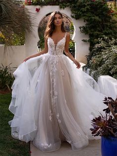 a woman in a wedding dress standing outside