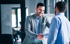 two men shaking hands in an office setting