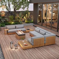 an outdoor living area with wooden flooring and grey couches on the outside deck