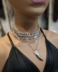 This handmade chunky stainless steel chain layered necklace set is a stunning piece of jewelry that is perfect for those who love bold and edgy accessories. The necklace features two necklaces, one thick chunky cover in an adjustable length, and a 4-strand drop festoon design, adding depth and dimension to the piece with a shiny Fang or cat's claw pendant.  The chunky chain is made of sturdy stainless steel, ensuring its durability and longevity.  This necklace set is an excellent handmade gift for someone special. It is a perfect choice for those who love alternative and goth styles, as well as anyone who wants to make a statement with their jewelry. It runs from 15 to 18 inches in length with a built-in extender. The necklace is waterproof and sweatproof and will never tarnish or fade! 2