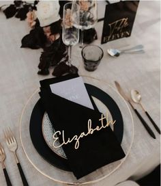 the table is set with black and white place settings