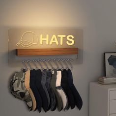 there is a hat rack with hats hanging on the wall next to a dresser and lamp