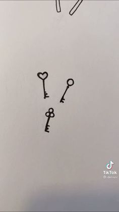 two keys are drawn in the middle of a piece of paper