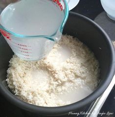 a measuring cup filled with rice on top of a stove