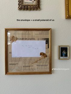 there are pictures on the wall and an old newspaper in front of them with words above it