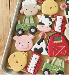 decorated cookies in the shape of farm animals and tractors