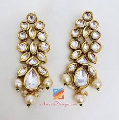 Ravishing Heavy High Quality White Kundan Set Necklace Earring Tikka Set. - High Quality Original Kundan Set - Necklace with Hanging Beads - Small Earrings - Small Elegant Tikka Shop for more KUNDAN SETS. Why Amazel Designs? Customer Testimonial - Aisha, Canada My experience with Amazel designs was amazing! She was super nice and the product was just as expected. It was beautiful and the quality was great! Thank you for the excellent and fast service! :) I will definitely be ordering more stuff! White Temple Jewelry Drop Earrings, White Hand Set Chandelier Earrings For Celebrations, Traditional Pearl Drop Jewelry For Anniversary, White Kundan Necklace With Matching Earrings In Temple Style, Temple Jewelry Style Beaded Kundan Earrings, Kundan Beaded Earrings For Temple Jewelry, White Drop Earrings For Festive Occasions, White Pearl Jeweled Jewelry, Festive White Jeweled Jewelry