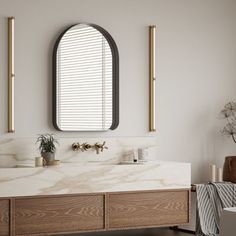 a bathroom with a sink, mirror and two vases on the counter in front of it