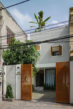 an entrance to a house with wooden slats on the sides and doors open in front