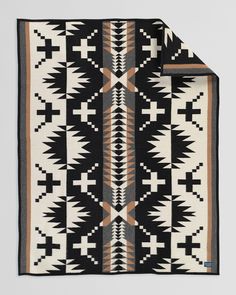 a black and white blanket with geometric designs