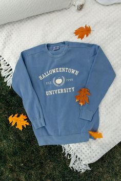 Being normal is vastly overrated. Show off your school spirit for the greatest University! This Halloween design is embroidered on a blue Comfort Colors sweatshirt with a light orange thread. This design is not customizable. This design and colors cannot be altered, resized, or changed. It is unisex sized. This means the sizing is boxy, not fitted like women's, but it is not oversized. It is true to size. 9.5 oz., 80/20 ring spun cotton/polyester Soft-washed garment-dyed fabric 1x1 rib on collar Custom Crewneck Sweatshirts, New England Fall, Comfort Colors Sweatshirt, Embroidered Crewneck, Halloween Town, Pumpkin Orange, Embroidered Sweatshirts, School Spirit, Fall Shirts