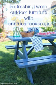 a blue picnic table with a sign that says refreshing worm outdoor furniture with one coat coverage