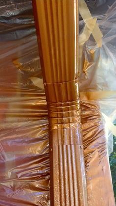 two wooden poles are wrapped in plastic