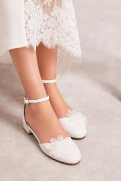 Introducing the exquisite Philippa bridal flats. An ode to timeless elegance and comfort. Each pair is handcrafted from top-quality leather and adorned with an elegant flower decoration made of delicate organza and tiny transparent beads. The romantic design of the Philippa flats features a rounded closed toe, with an open waist at the sides, allowing you to select the color that perfectly complements your wedding dress. Elevate your wedding experience with Philippa ballerinas, where beauty, comfort, and versatility unite. Whether you're walking down the aisle or standing by your loved one's side, these flats will ensure that every step you take is as graceful as your love story. Please order your usual dress shoe size. If you wear half size or you are between two sizes go DOWN to the near Festive Round Toe Wedding Shoes, Elegant Flat Mary Janes For Party, White Flat Heel Wedding Shoes, Elegant Closed Toe Wedding Shoes For First Communion, Spring Wedding Closed-toe Shoes, Closed Toe Wedding Shoes With Heel Strap, Spring Wedding Closed Toe Shoes, Elegant Closed Toe Shoes For First Communion, Cream Closed Toe Sandals For Wedding