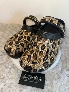 MyStyleMyWay's  custom crocs are designed for the perfect outfit, that special occasion, and "Just Because" you love blinged out crocs.  In the display shown we designed a pair of black "Cheetah Print Design" classic crocs adding high quality colorful rhinestones. 🐆Each Rhinestone is individually and neatly placed to achieve the design.  🐆Rhinestones are added to the top and buttom trimming of the shoe.  🐆This design was personalized. 🐆The sports mode strap is also designed.   🐆This design do not have charms or patches. charms can be added please contact us directly to discuss charm options.  🐆When making your purchase - You're making a purchase for the exact style shown. If you would like a different color rhinestone,  and or different charms please message us so we can assist you. Blinged Out Crocs, Bedazzled Crocs, Crocs Aesthetic, Bling Crocs, Cheetah Print Design, Womens Clogs And Mules, White Crocs, Classic Crocs, Custom Crocs