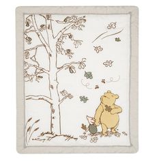 a winnie the pooh blanket hanging from a tree with leaves and flowers on it