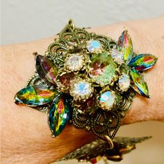 This Stunning Bracelet Is A One-Of-A-Kind Vintage Piece From The 1950s-60s. The Cuff Style Bracelet Is Made With A Mix Of Glass, Rhinestone, And Crystal Materials, And Features A Beautiful Multicolor Design That Is Perfect For Any Occasion. The Bracelet Is Adjustable For A Comfortable Fit, And Has A Toggle Closure. It Measures Approx 7 Inches In Length And Is A Great Addition To Any Jewelry Collection. This Vintage Bracelet Is Handmade And Has A Unique Assemblage Of Vintage Clip Earrings From Va Adjustable Vintage Cuff Bracelet, Multicolor Retro Jewelry For Vintage Collection, Vintage Jubilee Cuff Bracelet As Gift, Retro Multicolor Bangle Jewelry, Vintage Jubilee Cuff Bracelet Gift, Vintage Multicolor Cuff Bracelet Bangle, Adjustable Multicolor Vintage Cuff Bracelet, Vintage Multicolor Bracelets, Vintage Jeweled Cuff Bracelet