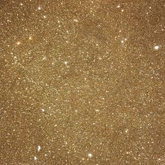 an image of some gold glitter with stars in the sky on this night time background