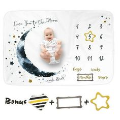 a baby laying on top of a blanket next to some magnets and other items