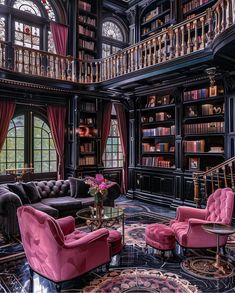 a living room filled with lots of furniture and bookshelves next to a stair case