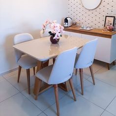 a white table with four chairs around it