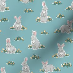 a blue background with rabbits and flowers on it