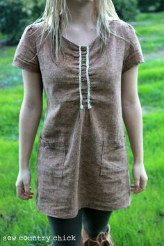 a woman standing in the grass with her eyes closed and mouth wide open, wearing brown boots