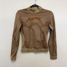 Kappa Authentic Jaworzno Logo Print Long Sleeve Tight Shirt Beige Brown Size M/L | eBay Winter Sporty Fitted Tops, Fitted Crew Neck T-shirt In Khaki, Sporty Stretch Brown Tops, Sporty Brown Stretch Top, Fitted Beige T-shirt Crew Neck, Fitted Beige Crew Neck T-shirt, Sporty Brown Long Sleeve Tops, Beige Fitted Crew Neck T-shirt, Brown Long Sleeve Sporty Tops