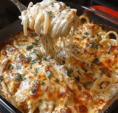 a fork full of pasta being lifted from a casserole dish