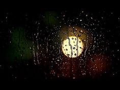 rain drops on a window with the moon in the background