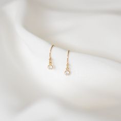 Simple and perfect for everyday wear, these dainty earrings feature a 3mm brilliant dangling cubic zirconia charm. These are all made of 14K gold filled materials and are tarnish-resistant, water-resistant, and hypoallergenic.  Comes with box and jewelry pouch, ready for gifting. --------------------♥ PROMOS ♥-------------------- Want 10% off? Join the mailing list by visiting http://bit.ly/vedern . Just leave me a note at checkout if you have any problems applying discount codes. --------------------♥ BUY WITH CONFIDENCE ♥-------------------- Don't love it? Message me to set up a return or exchange. If you find any problems with your items, just send a message with a photo, and a new one will be on its way to you! --------------------------♥ PACKAGING ♥--------------------------- Gold fil Gold Hypoallergenic Dainty Diamond Earrings, Dainty Gold Hypoallergenic Diamond Earrings, Gold Dainty Hypoallergenic Diamond Earrings, Dainty Gold Diamond Hypoallergenic Earrings, Minimalist Gold Plated Diamond Drop Earrings, Dainty Gold Diamond Earrings With Ear Wire, Dainty Rose Gold Diamond Earrings For Everyday, Everyday Dainty Rose Gold Diamond Earrings, Delicate 14k Gold Hypoallergenic Earrings