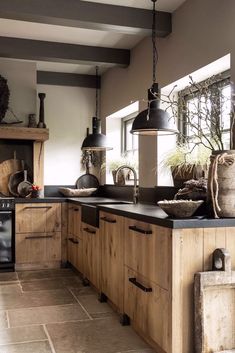 a kitchen with wooden cabinets and black appliances