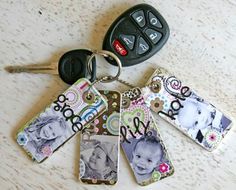 four keychains with different pictures on them next to a car remote control device