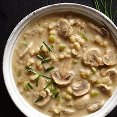 a white bowl filled with mushroom soup on top of a table