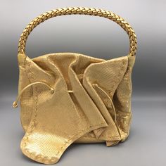 Fatto A Mano By Carlos Falchi Metallic Gold Buffalo Bag The It-Bag Of The 80's, The Silhouette Is The Most Iconic Of Falchi's Designs. A Must For Collectors, A Stunner For All! Approx. Size: Handle Drop: 5" Height: 8" Width: 10" Depth: 3" Magnetic Flap Closure. Single Braided Handle. Interior Zipper Pocket. Suede & Multi-Color Lining. Original Dust Bag. Nwot. Never Worn. Smoke-Free Storage. 5 Star Rated Seller. Fast Shipping. Authenticity Guaranteed. Designer Gold Bucket Bag For Everyday Use, Designer Gold Bucket Bag With Dust Bag, Designer Gold Bucket Shoulder Bag, Gold Rectangular Bucket Bag With Handles, Gold Top Handle Hobo Bag For Evening, Designer Gold Bucket Bag With Detachable Handle, Gold Handheld Bucket Bag With Removable Pouch, Gold Hobo Bag For Formal Occasions, Handheld Gold Bucket Bag With Removable Pouch