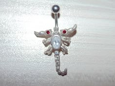 "Link to store: https://www.etsy.com/shop/VintageJewelryEden SOLD SEPARATELY New Handmade Belly button ring Shape: Moveable Scorpion / Leaping Dolphins(sold) / Iguana Lizard / Clear and Blue Spiders Barbell is standard 14 gauge, 3/8\" long made of hypoallergenic surgical stainless steel Dangle elements are sterling silver, stamped 925 All crystal cubic zirconia Colors: Various SHIPPING WORLDWIDE" Scorpion Belly Button Ring, Adjustable Rhinestone Body Jewelry Gift, Adjustable Rhinestone Body Jewelry For Gift, Silver Jeweled Body Jewelry Gift, Silver Jeweled Body Jewelry For Gifts, Adjustable Silver Jeweled Body Jewelry, Snake Belly Button Piercing, Piercing Bar, Bellybutton Piercings