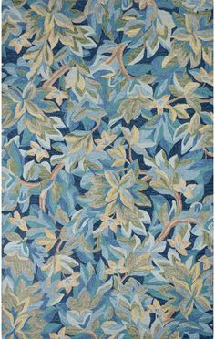 an area rug with blue and green leaves on it