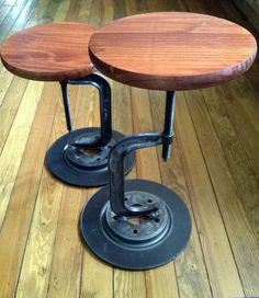 two wooden stools sitting on top of a hard wood floor next to each other