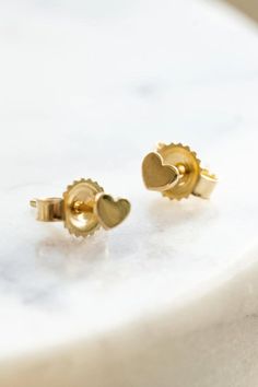 Tiny Gold Heart Stud Earrings - 4mm by Wild Moonstone | Jewelry with purpose | based in Northern California | making Jewelry for you and the people you love. Absolutely adorable, comfortable and solid gold. They are perfect for anyone that loves dainty studs. Shop the collection! stud earrings, heart stud earrings, gold heart stud earrings, gold jewelry, minimalist earrings, minimalist jewelry, everyday wear jewelry, gold jewelry gift, mini stud earrings, mini gold heart earrings Dainty Yellow Gold Heart Earrings, Dainty Tiny Heart Earrings Gift, Dainty Tiny Gold Heart Earrings, Tiny Elegant Heart-shaped Earrings, Tiny Heart-shaped Gold Earrings, Gold Heart Stud Earrings, Gold Heart Earrings, Jewelry Everyday, Gold Heart Studs