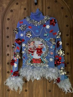 a blue sweater with santa clause on it