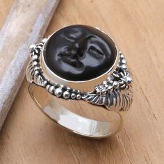 Buana looks into Egyptian mythology and is inspired by Amun-Ra the creator deity. As Amun he represents that which is hidden (the sun at night) whilst in Ra he represents revealed divinity (the sun during the day). Buana carves his ebony wood face with admirable detail and sets it on a highly ornate sterling silver ring. .925 Sterling silver Mystical Black Ring As Gift, Spiritual Black Rings, Black Symbolic Adjustable Rings, Adjustable Black Symbolic Rings, Black Handmade Symbolic Rings, Unique Black Moon Phase Jewelry, Handmade Symbolic Black Rings, Handmade Black Symbolic Rings, Unique Black Jewelry With Moon Phase