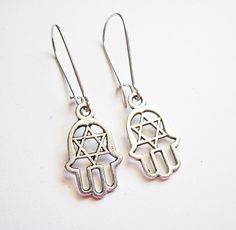 Hamsa Earrings, silver Hamsa charms, Hamsa jewelry, Jewish Jewelry earrings silver earrings Yoga earrings, dangle earrings, secured earwires Beautiful silver hamsa hands dangle from leverbacks ear wires. A matching bracelet is available in my shop. ☆ Silver plated leverbacks ☆ Silver plated Hamsa charms are 12 x 20 mm (0.5 x 0.8 inches) ☆ On Sale! Looking for the MATCHING BRACELET of the last picture? You can find it here: https://www.etsy.com/listing/96535592/silver-hamsa-bracelet-hamsa-charm-h Silver Symbolic Pendant Earrings, Symbolic Silver Pendant Earrings, Symbolic Metal Dangle Earrings, Spiritual Silver Jewelry With Matching Earrings, Symbolic Dangle Jewelry With Ear Wire, Symbolic Dangle Plug Earrings For Pierced Ears, Symbolic Drop Earrings With Ear Wire, Nickel Free Dangle Plug Earrings For Gift, Symbolic Silver Dangle Jewelry