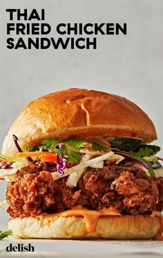 a fried chicken sandwich with lettuce and carrots