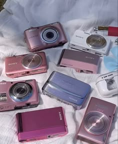 there are many different types of cameras on the bed