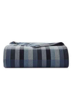 a blue and black plaid blanket on a white background