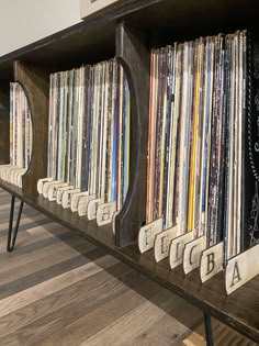 an old record player's console with records on the shelves and letters spelling out